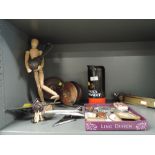 A selection of curios and trinkets including pipe heads fishing reel and Corgi concorde