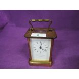 A brass and glass bodied carriage clock by Matthew Norman of London (no key)