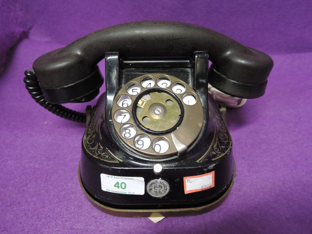 A vintage metal bodied and transfer printed telephone by Bell