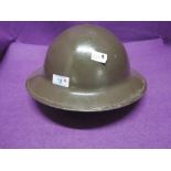 A World War II British military helmet, stamped on inside R. O. Co DM 1939