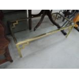 A heavy brass and glass coffee table