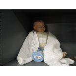A English style 1950's composition doll having painted eyes, open mouth and jointed body, wearing