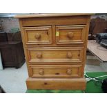 A traditional pine bedside chest of drawers