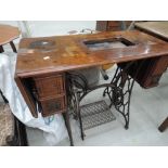 A Victorian sewing machine table having treadle movement