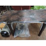 A vintage coffee table, of stylised design with chrome embellishments