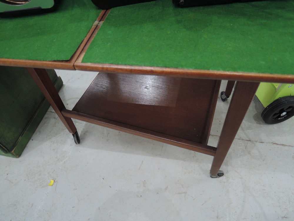 A vintage fold over tea/games trolley with green baize top