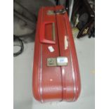 A red leather style suitcase