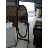 A modern dark stained cheval mirror