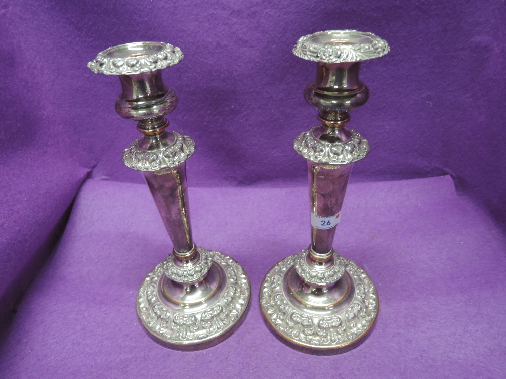 A pair of Sheffield plate weighted candle sticks of classical form having removable sconces, tapered