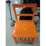 A classic childs chair painted sun burnt orange