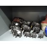 A selection of graduated hand carved and similar African elephants