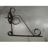 A cast and wrought iron wall or gas light bracket