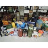 A large collection of tins , including tea cannisters and tobacco tin