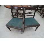 A pair of late Victorian mahogany rail back dining chairs