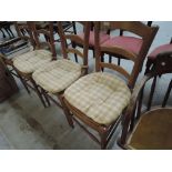 A set of four modern beech effect kitchen chairs