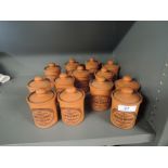 A selection of terracotta kitchen spice jars the Suffolk Cannister