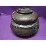 An antique copper and brass lidded container of middle eastern design