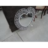A modern decorative heart shaped wall mirror