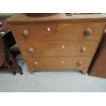 A traditional stripped three drawer chest