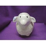 A ceramic figure of a sheep