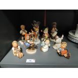 Nine Hummel and similar figures and ornaments including Pumpkin Pie Boy, Apple Tree Girl, Angels