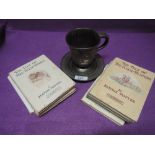A pewter cup and saucer and selection of Beatrix potter volumes (reprints)