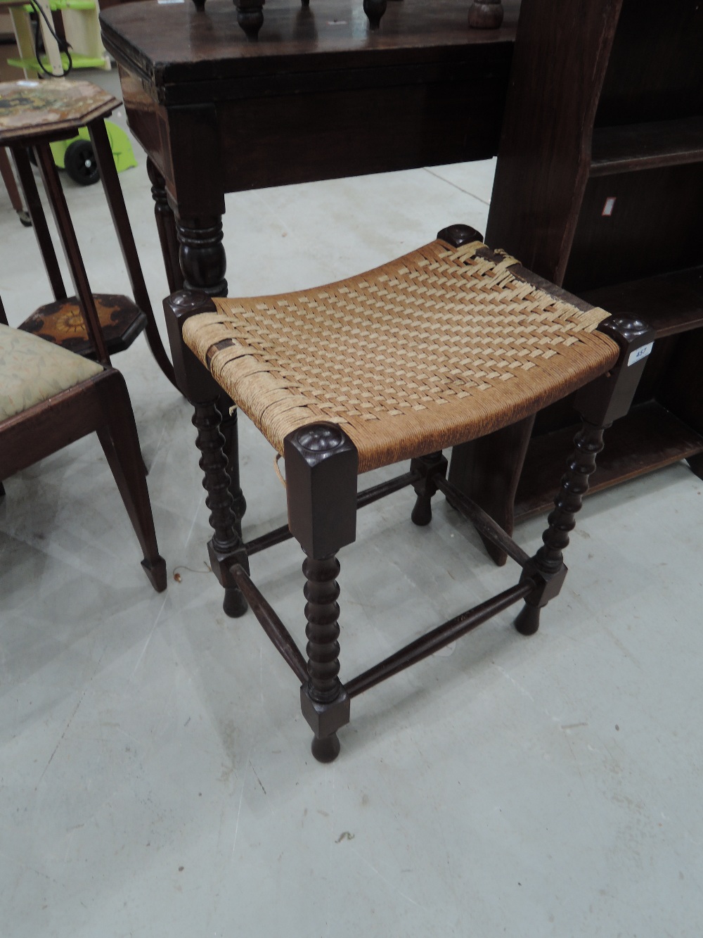 A vintage mahiogany footstool having turned frame
