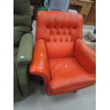 A vintage orange swivel chair