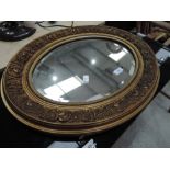 A vintage gilt frame oval wall mirror