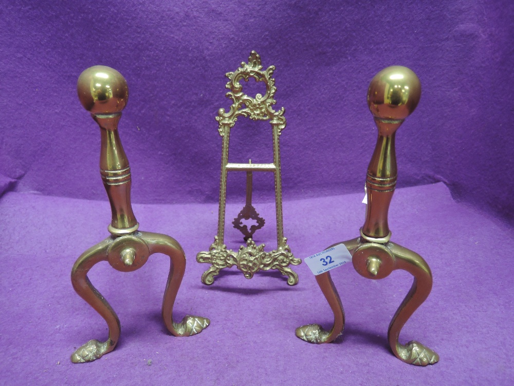 A set of brass fire dogs and picture stand