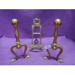 A set of brass fire dogs and picture stand