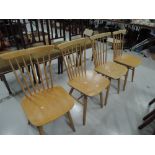 A set of four Ercol style beech spindle back chairs