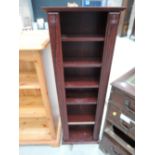 A laminate Rosewood effect book/CD shelf unit