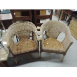 A pair of wicker tub chairs