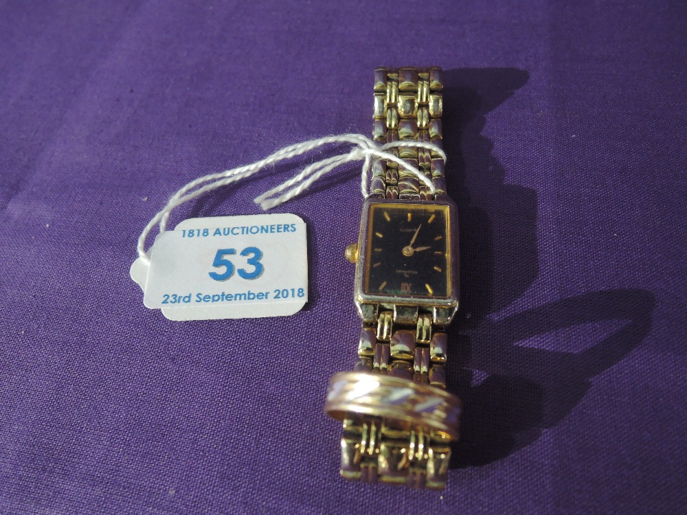 A lady's gold plated wrist watch by Hallmark having baton dial to black face on bracelet strap and a