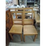 A set of five modern solid seat kitchen chairs