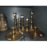 A selection of brass candle sticks including British made