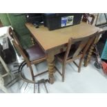 A mid 20th Century oak drawer leaf table and set of 4 chairs
