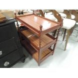 An early to mid 20th Century oak tea trolley having later formica additions