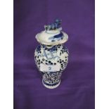 A hard paste Chinese export lidded urn with hand decorated imagery AF