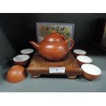 A terracotta Chinese stamped saki or miniature tea set