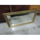 A modern gilt frame wall mirror