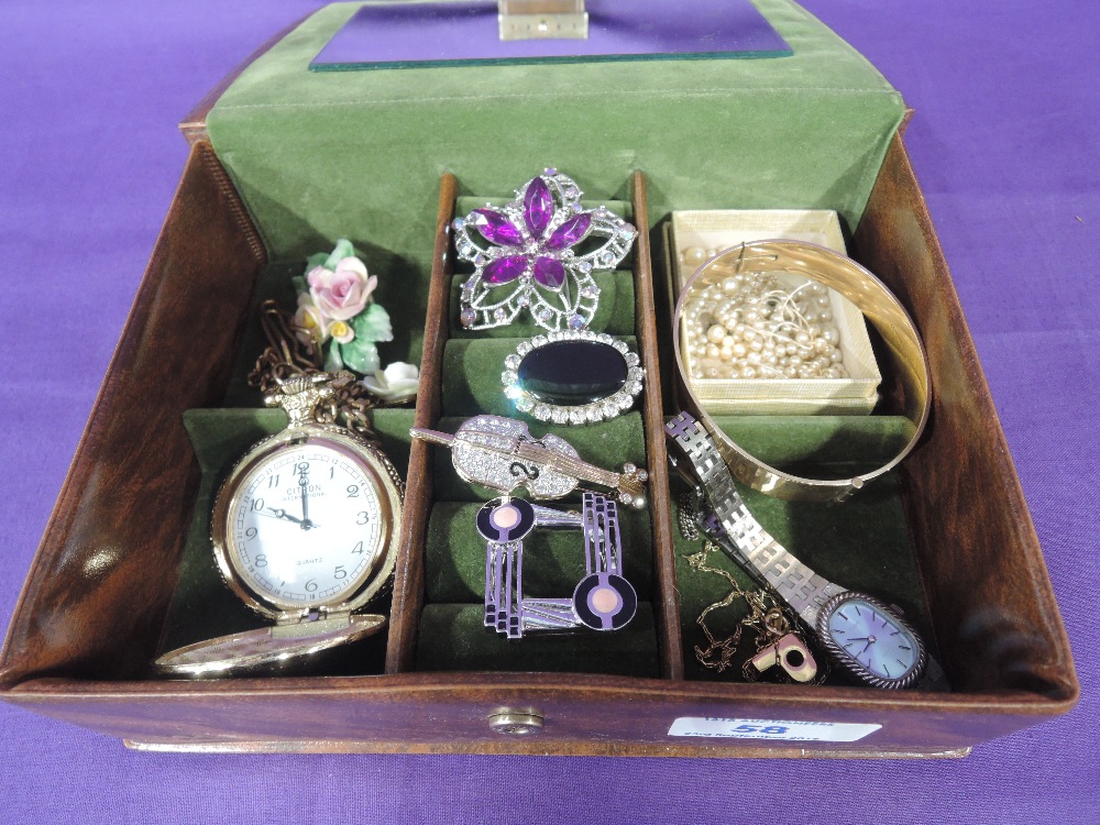 A small jewellery box containing a selection of costume jewellery including brooches, Pulsar