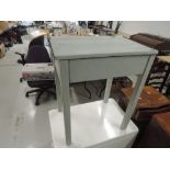 A vintage school desk, painted in light grey