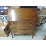 An early 20th Century mahogany bureau on cabriole legs