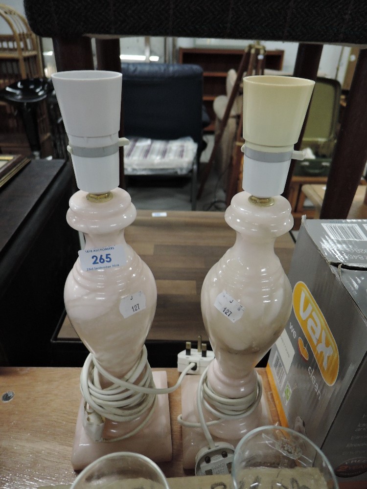 A pair of pink stone cut lamp bases