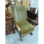 An early to mid 20th Century oak framed rocking chair, possibly Parker Knoll