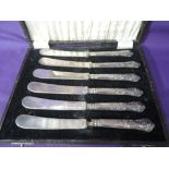 A cased set of silver handled butter knives in the Kings pattern stamped Sterling Silver