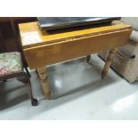 A 19th Century stained pine drop leaf kitchen table