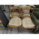 A set of four modern beech effect kitchen chairs